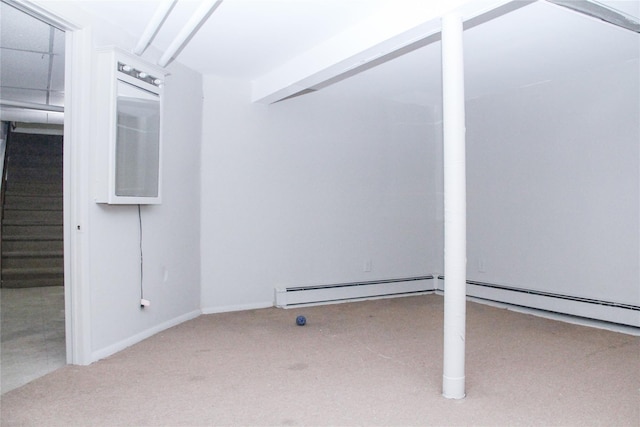 basement with a baseboard radiator and light colored carpet