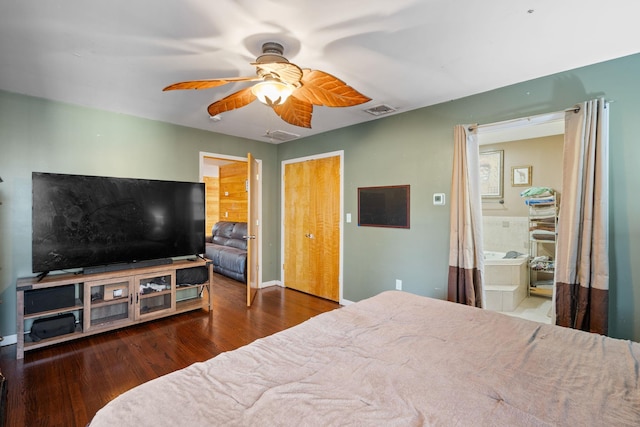 bedroom with ceiling fan, dark hardwood / wood-style floors, and connected bathroom