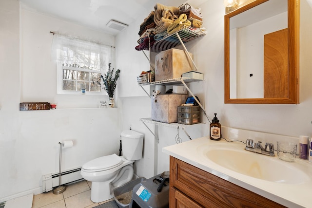 bathroom featuring baseboard heating, tile patterned flooring, vanity, and toilet