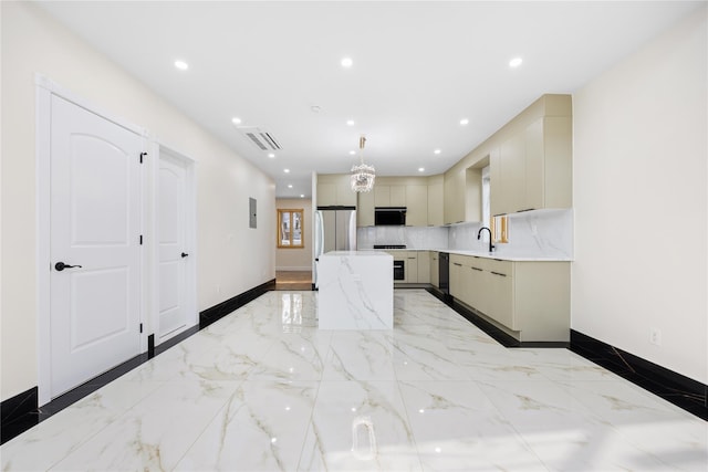 kitchen featuring stainless steel refrigerator, pendant lighting, light stone counters, and cream cabinetry