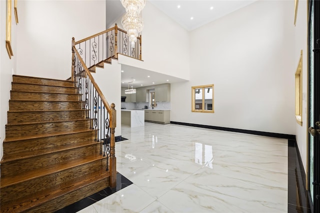 foyer featuring a high ceiling and an inviting chandelier