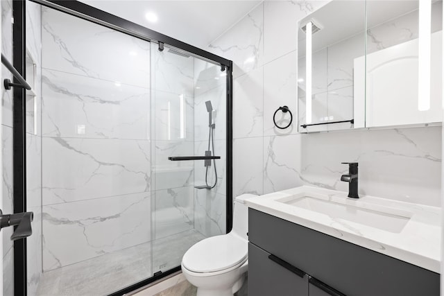 bathroom featuring tile walls, backsplash, vanity, toilet, and walk in shower