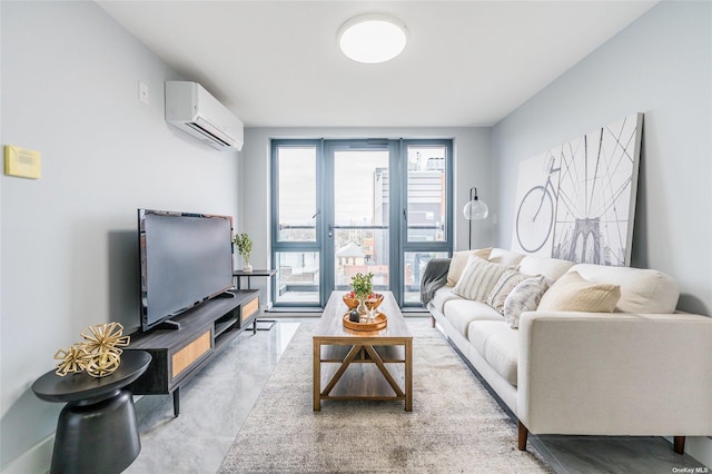 living room with concrete floors and a wall unit AC