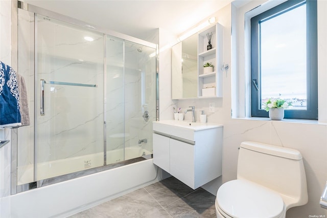 full bathroom with shower / bath combination with glass door, vanity, and toilet