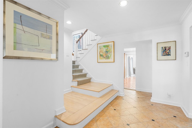 stairs featuring baseboards, ornamental molding, and recessed lighting