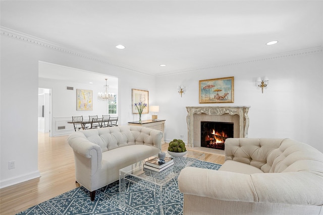 living area featuring a premium fireplace, wood finished floors, visible vents, and recessed lighting