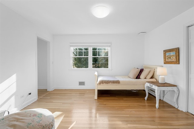 bedroom featuring light wood-style floors, baseboards, and visible vents