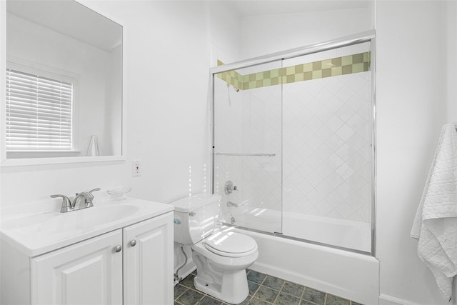 bathroom featuring toilet, shower / bath combination with glass door, and vanity