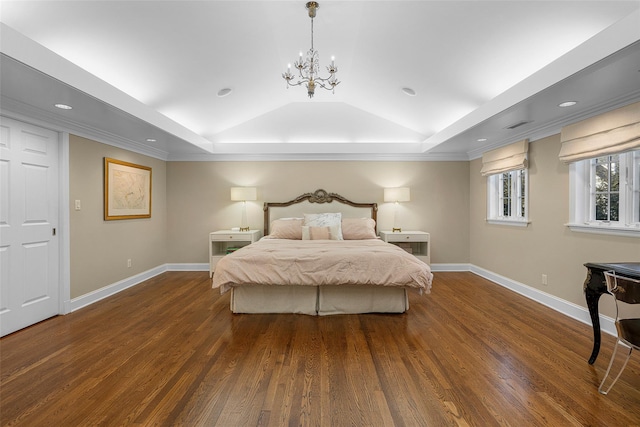 bedroom with lofted ceiling, baseboards, a tray ceiling, and dark wood-style flooring