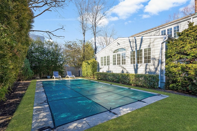 view of swimming pool with a fenced in pool, fence, and a lawn