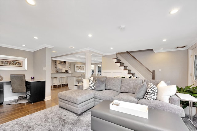 living room with ornamental molding and hardwood / wood-style flooring