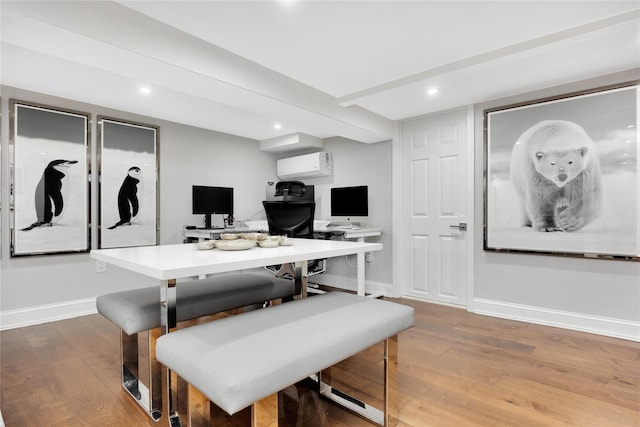 dining room featuring an AC wall unit and light wood-type flooring