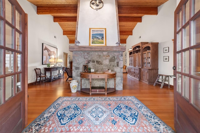 living room with beam ceiling, french doors, high vaulted ceiling, and hardwood / wood-style flooring