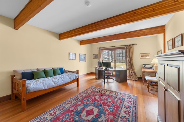 interior space with light hardwood / wood-style flooring and beamed ceiling