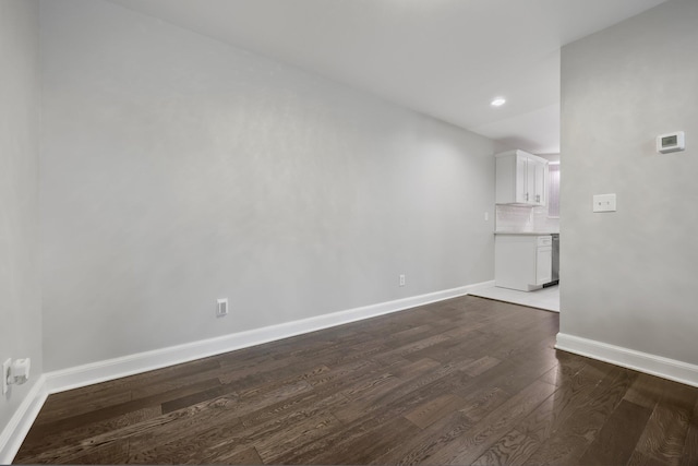 empty room with dark wood-type flooring