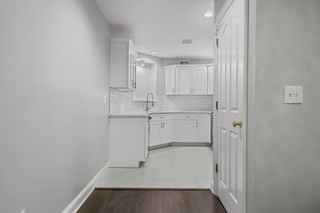 kitchen featuring white cabinetry and backsplash