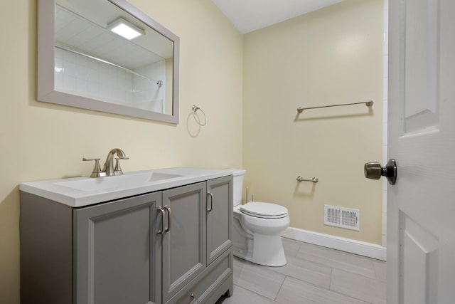 bathroom featuring toilet and vanity