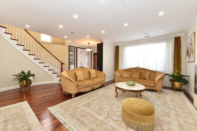 living room with wood-type flooring and ornamental molding