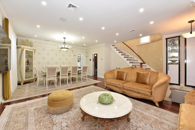 living room with crown molding and hardwood / wood-style floors