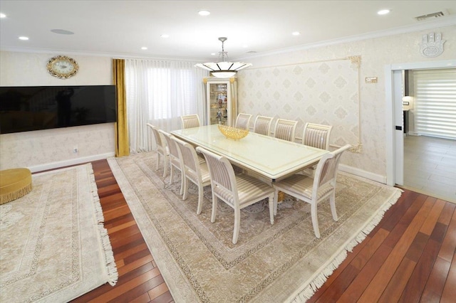 dining area featuring dark wood-type flooring and ornamental molding