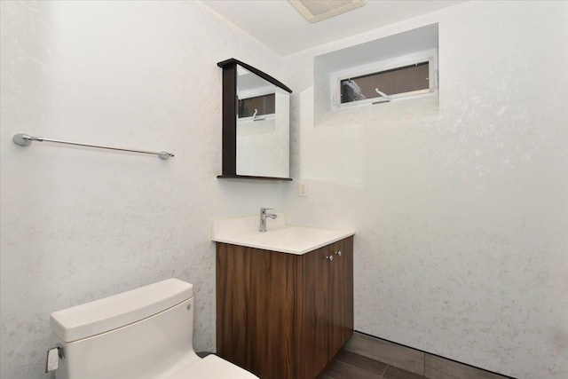 bathroom featuring vanity and toilet