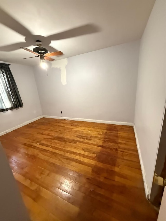 unfurnished room with ceiling fan and wood-type flooring