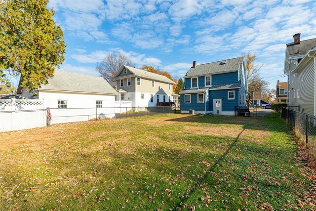rear view of property with a lawn