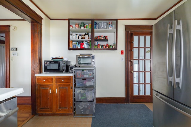 kitchen with ornamental molding and stainless steel appliances