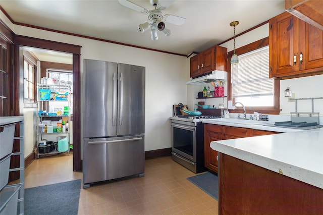 kitchen with ornamental molding, appliances with stainless steel finishes, ceiling fan, and pendant lighting