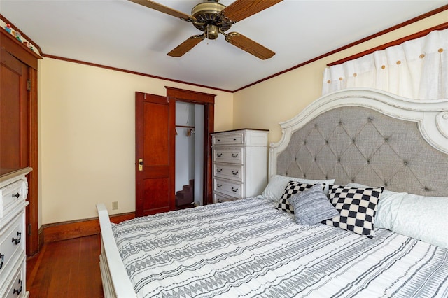 bedroom featuring dark wood-type flooring, ceiling fan, and crown molding
