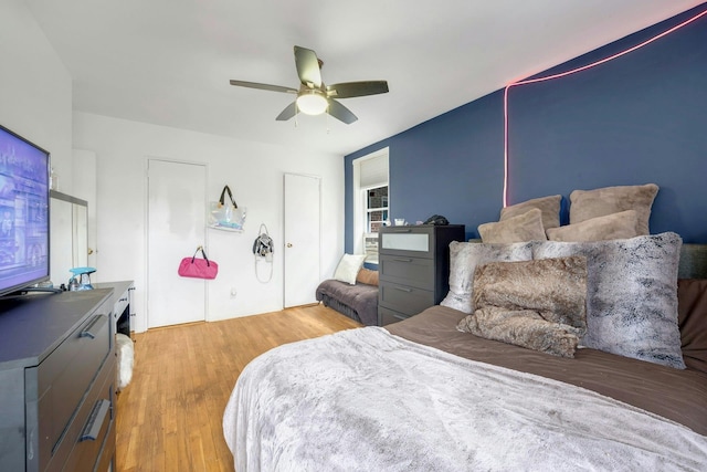 bedroom with light hardwood / wood-style flooring and ceiling fan