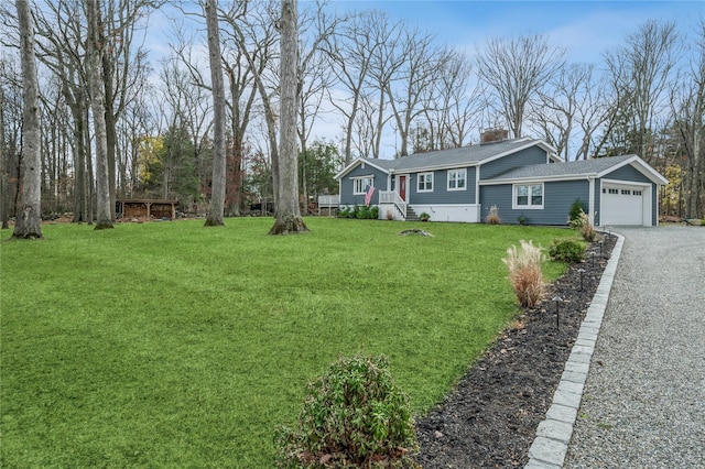 view of front of home with a garage and a front lawn