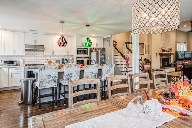 dining space featuring dark hardwood / wood-style floors and a fireplace