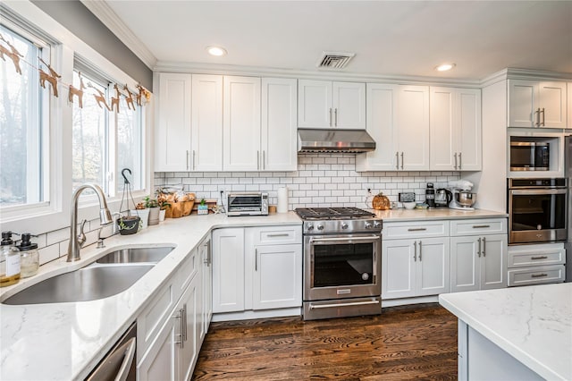 kitchen featuring white cabinets, appliances with stainless steel finishes, and ventilation hood