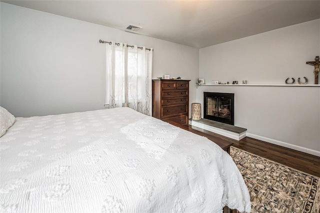 bedroom with hardwood / wood-style floors