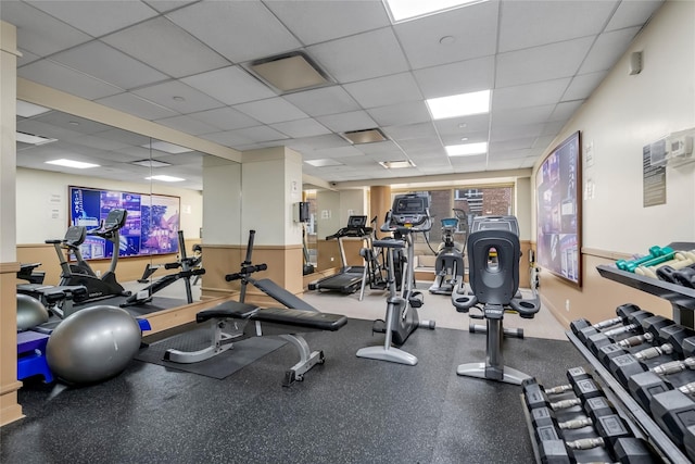 workout area with a paneled ceiling