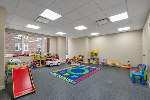 recreation room featuring a paneled ceiling