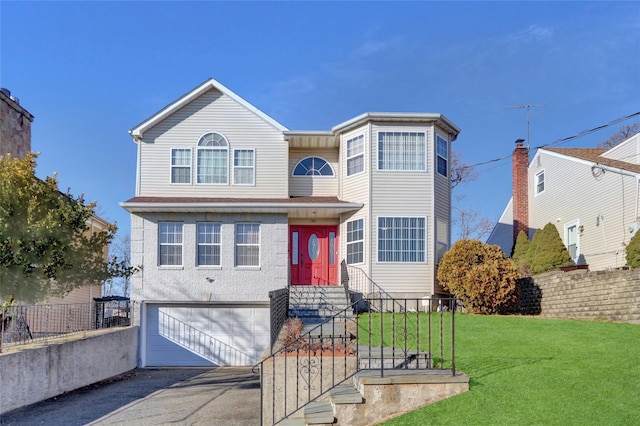 view of front of house with a front lawn and a garage