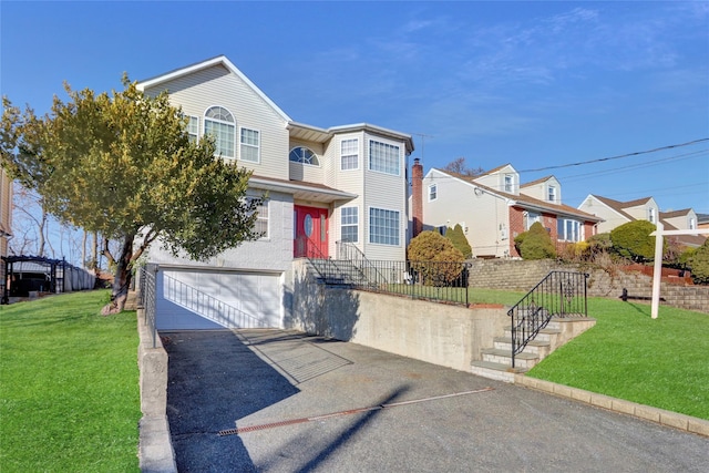 view of front of home featuring a front yard and a garage