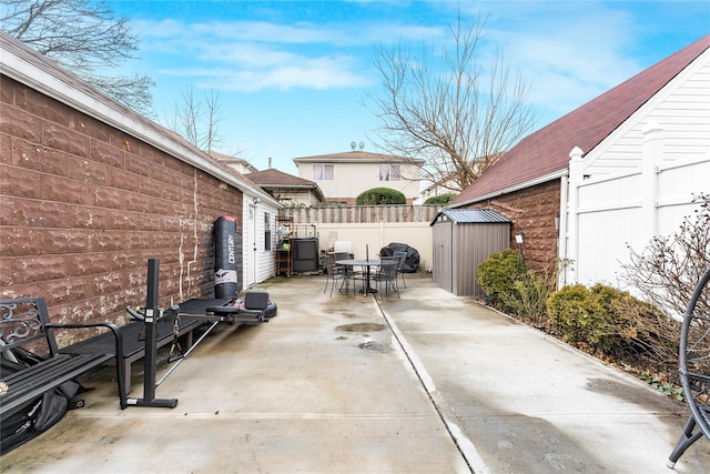 view of patio with a storage unit