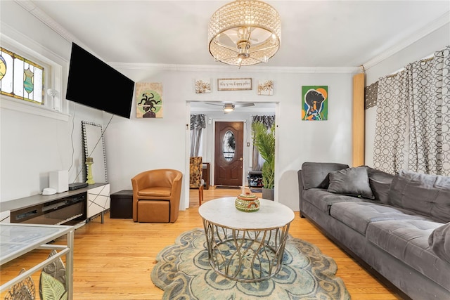 living room featuring ceiling fan, crown molding, and wood-type flooring