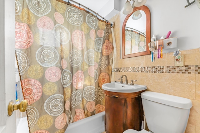 full bathroom with vanity, shower / bath combination with curtain, toilet, and tile walls