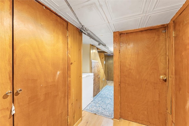 hallway featuring washer / dryer and light wood-type flooring