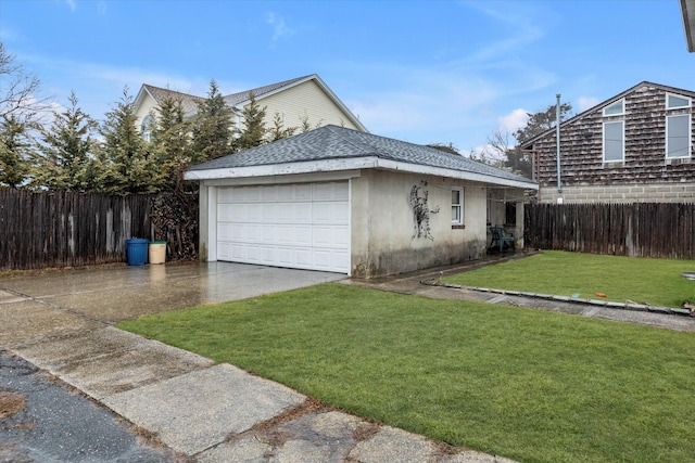 view of home's exterior with a yard, a garage, and an outbuilding