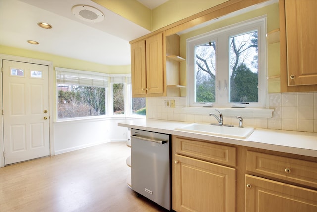 kitchen featuring light brown cabinetry, backsplash, a wealth of natural light, sink, and dishwasher