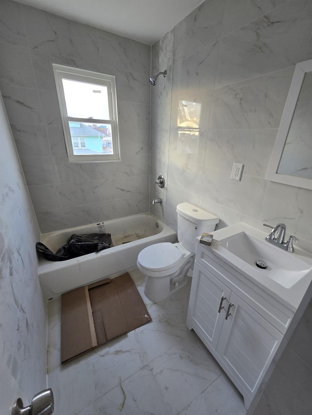 full bathroom with vanity, tiled shower / bath combo, and toilet