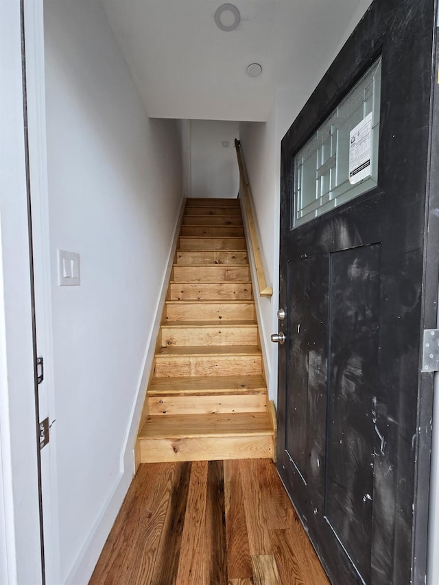 stairway with wood-type flooring