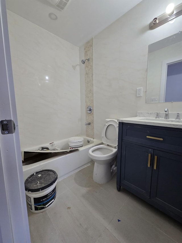 full bathroom featuring tile patterned floors, vanity, toilet, and shower / washtub combination