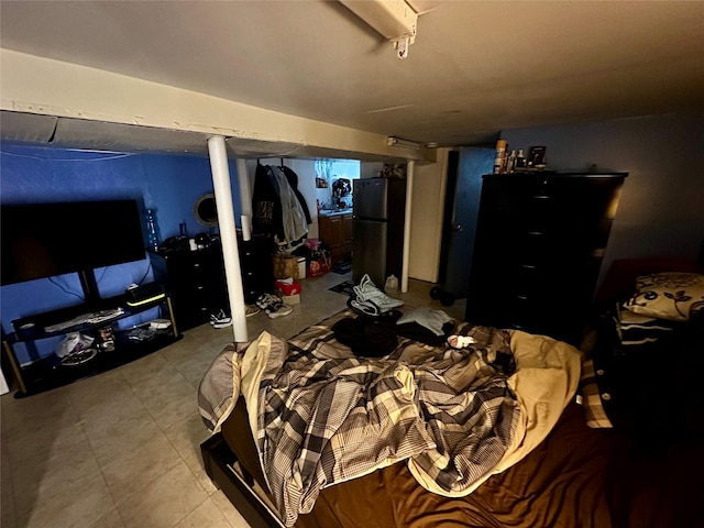 bedroom featuring freestanding refrigerator