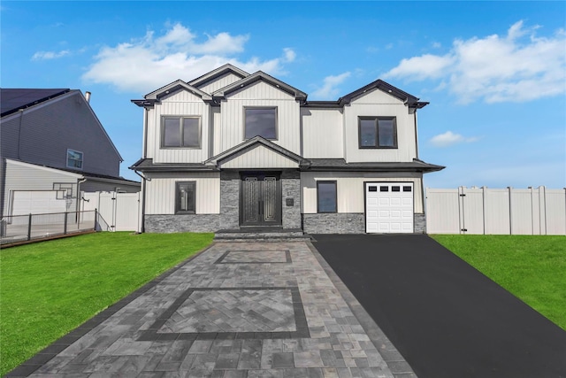 view of front of house featuring a front yard and a garage